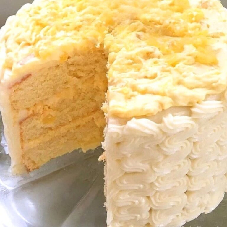 Moist Pineapple Cake, sliced, on a cake plate.