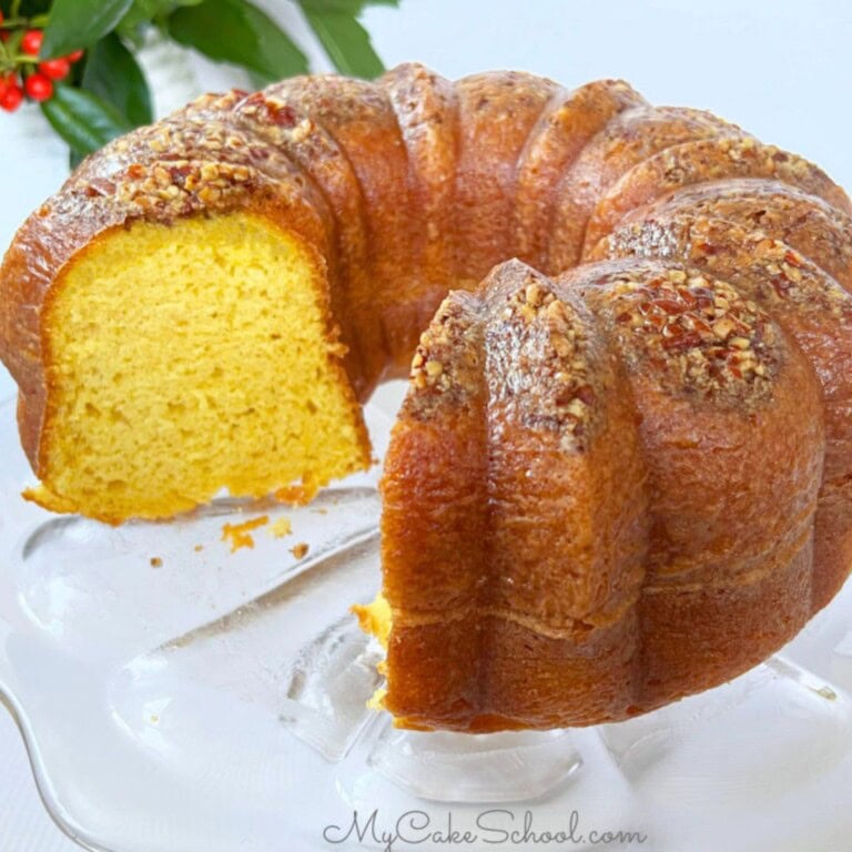 easy rum cake, sliced, on a cake pedestal.