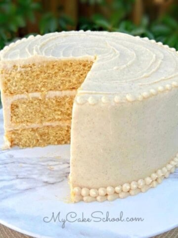 Easy Banana Cake, sliced, on a cake pedestal.