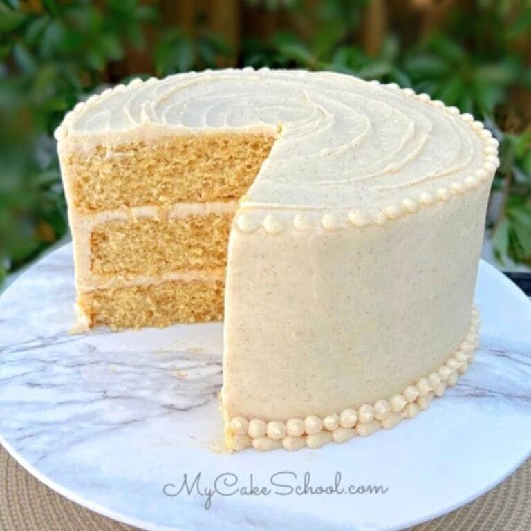 Easy Banana Cake, sliced, on a cake pedestal.