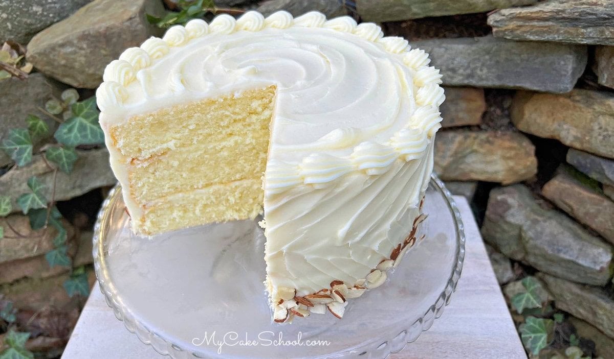 Almond Cream Cake, sliced, on a pedestal.