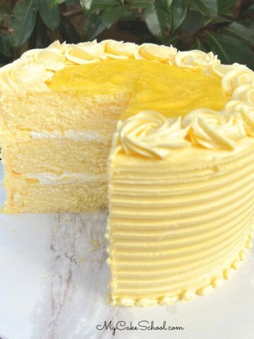 Lemon Velvet Cake, sliced, on a cake pedestal.