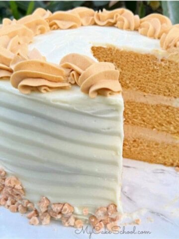 Butterscotch Cake, sliced, on a cake pedestal.