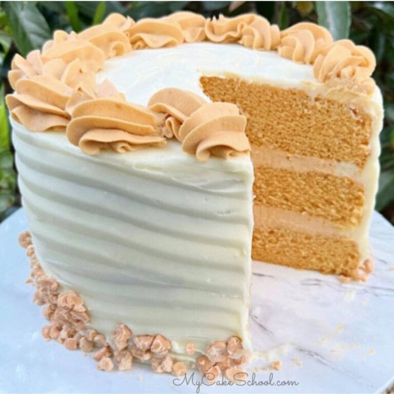 Butterscotch Cake, sliced, on a cake pedestal.