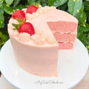 Homemade Strawberry Cake, sliced on a cake pedestal.