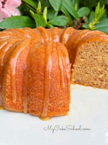 Banana Pecan Bundt Cake, sliced, on a cake pedestal.