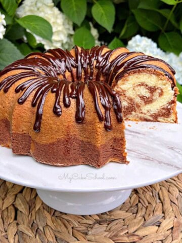 Marble pound cake, sliced, on a cake pedestal.