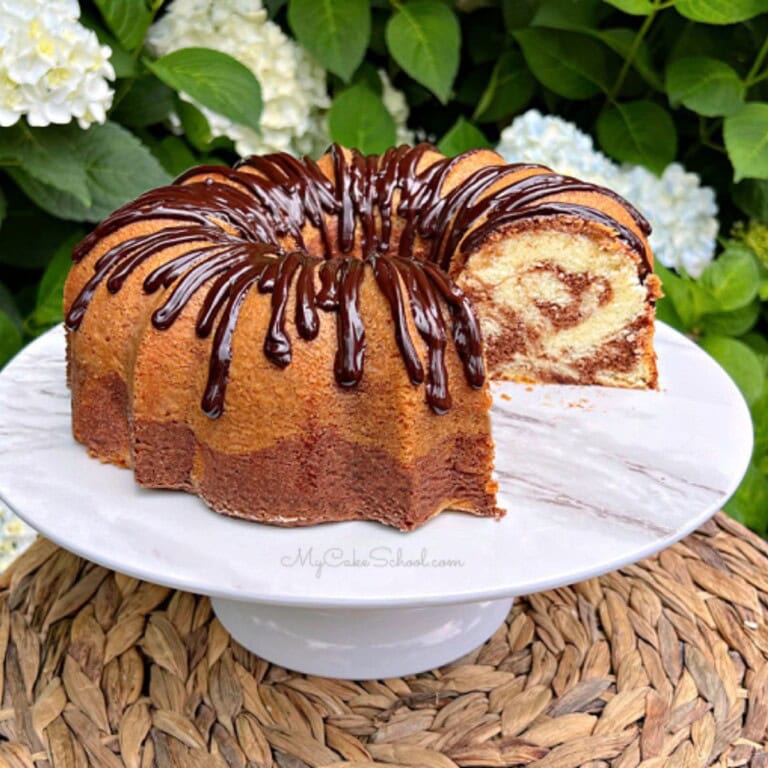 Marble pound cake, sliced, on a cake pedestal.