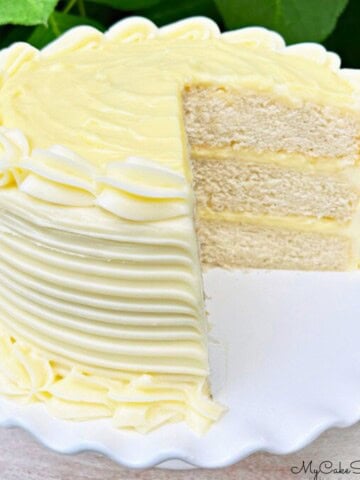 Banana Cream Cake, sliced, on a cake pedestal.