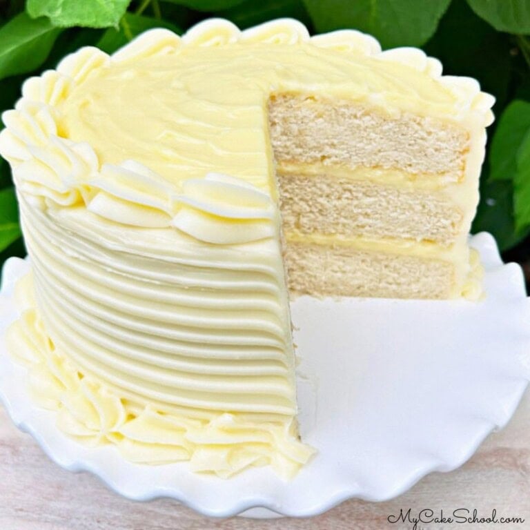 Banana Cream Cake, sliced, on a cake pedestal.