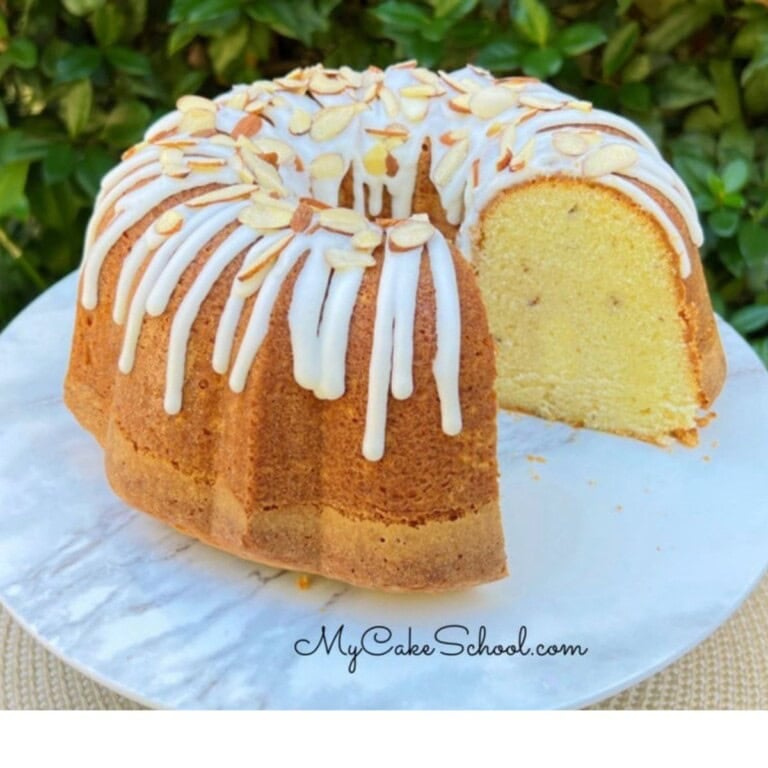 Almond Sour Cream Pound Cake, sliced, on a cake pedestal.