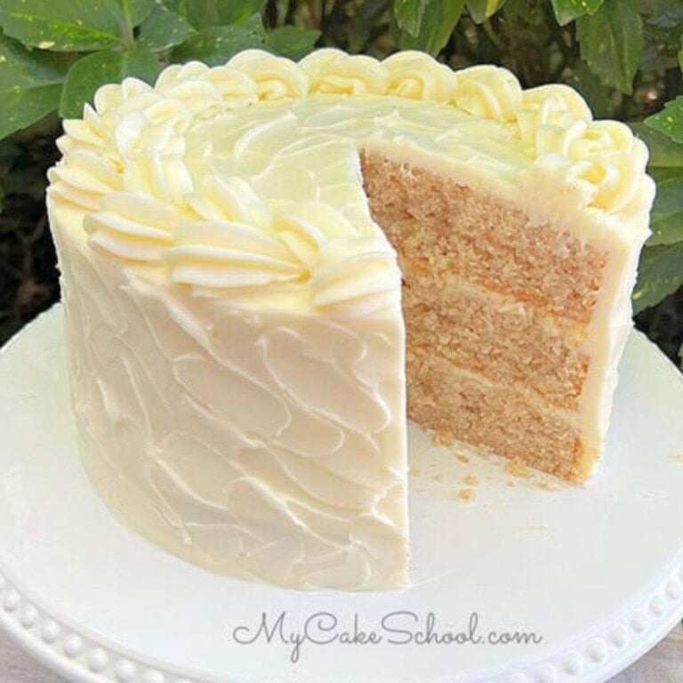 Apple Cinnamon Cake, sliced, on a cake pedestal.