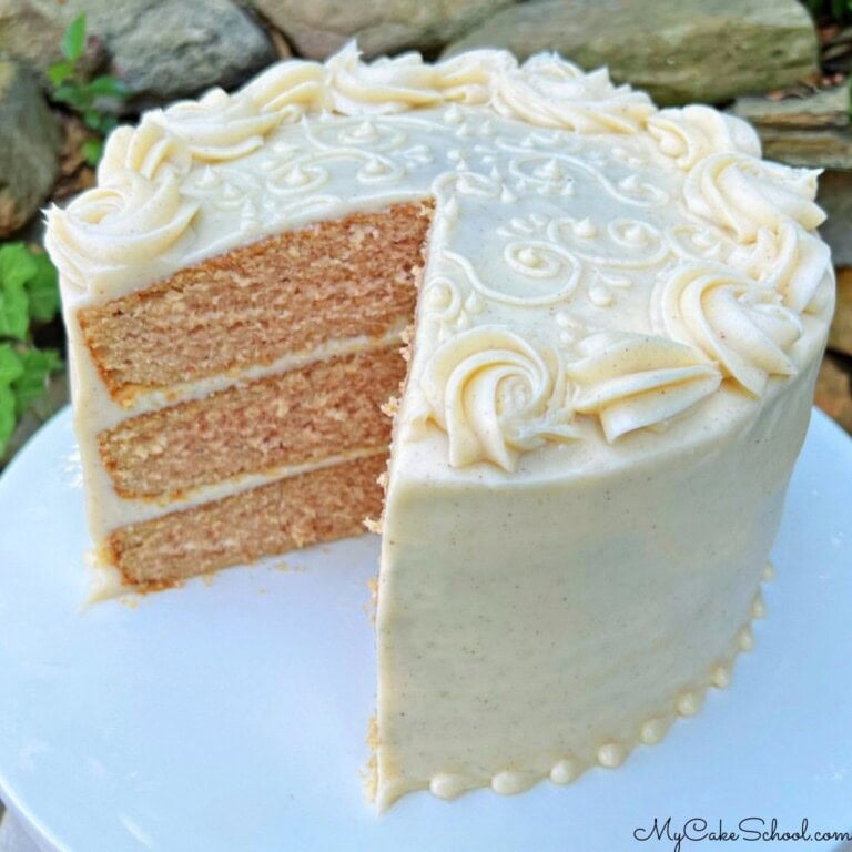 Applesauce Spice Cake, sliced, on a cake pedestal.