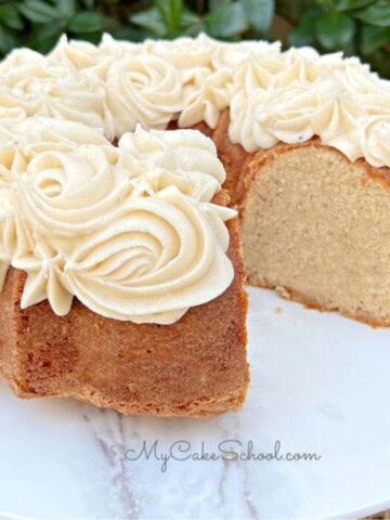 Eggnog pound cake, sliced, on a cake pedestal.