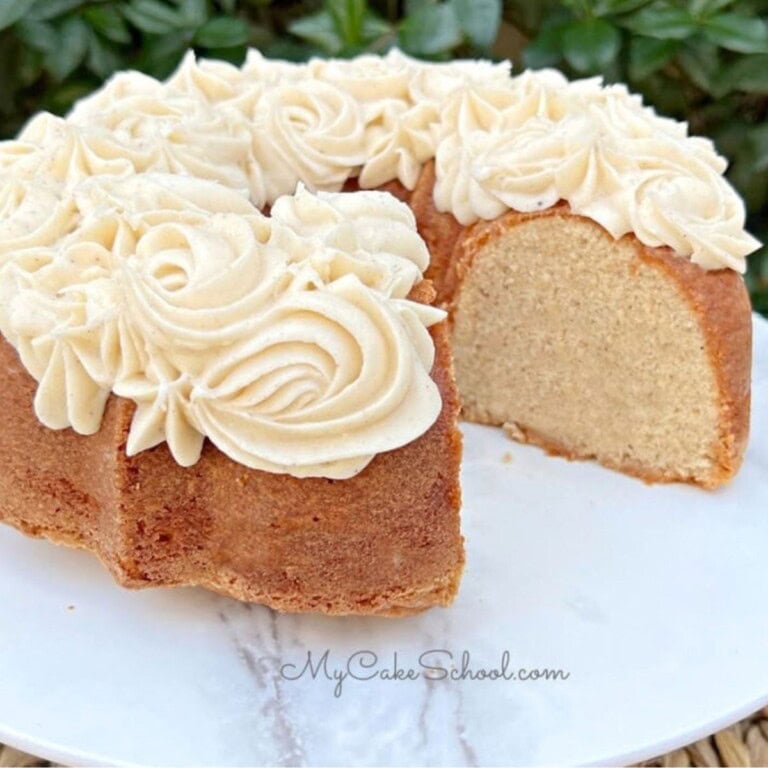 Eggnog pound cake, sliced, on a cake pedestal.