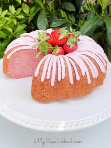 Sliced Strawberry Bundt Cake on White Pedestal.