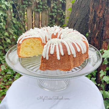 Sliced Pineapple Coconut Pound Cake on a cake pedestal.