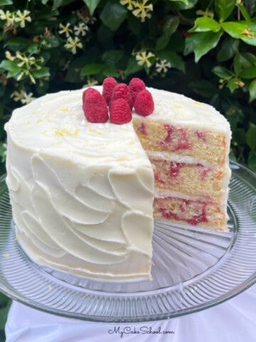 Sliced Lemon Raspberry Swirl Cake on a pedestal.