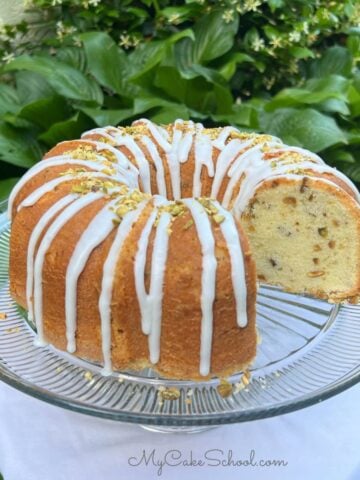 Pistachio Pound Cake, sliced, on a cake pedestal.