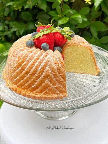 Vanilla Bundt Cake, sliced, on a cake pedestal.