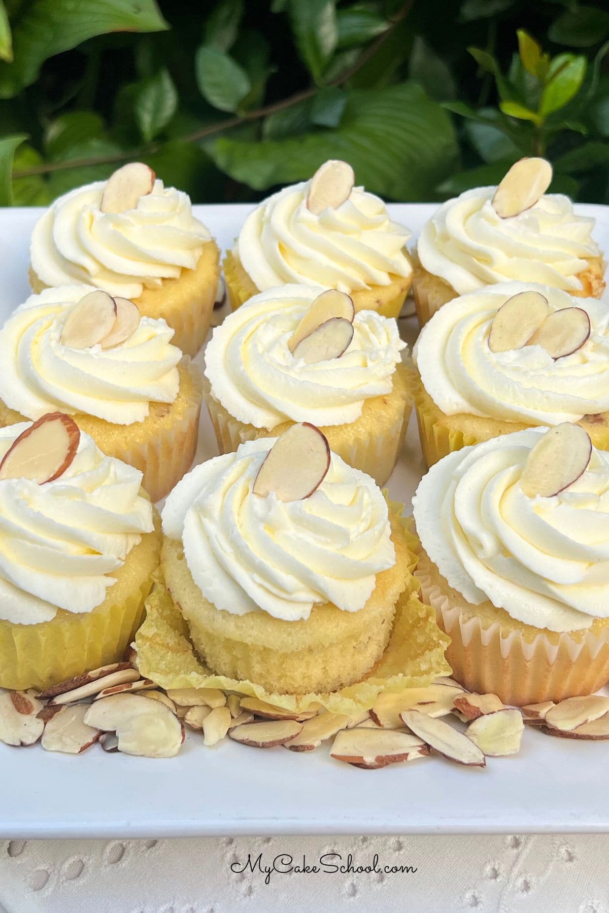 Almond Cupcakes on a platter, swirled with almond frosting.