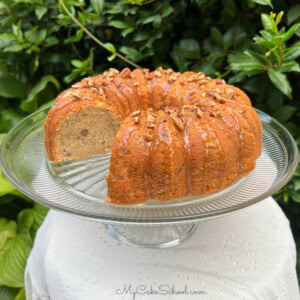 Banana Nut Cake, sliced, on a cake pedestal.