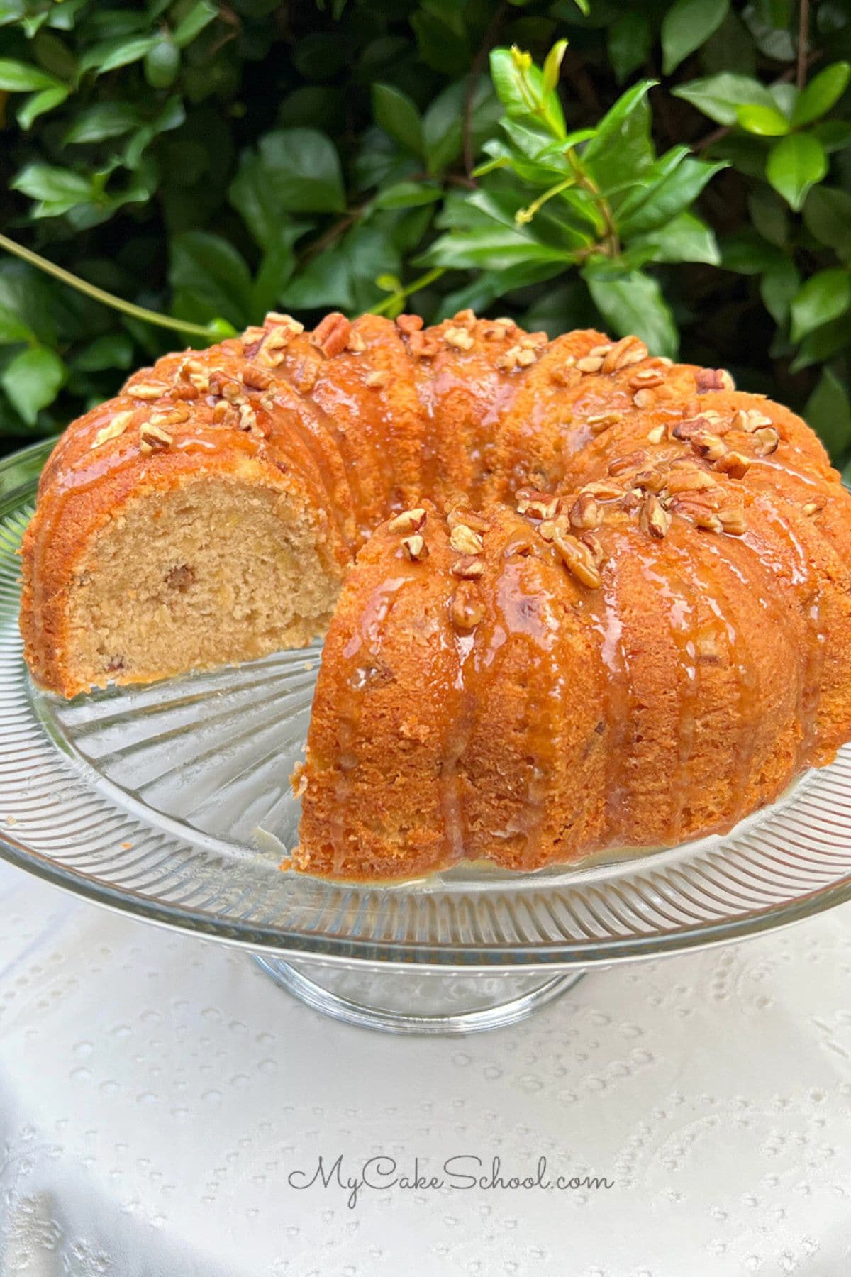 Banana Nut Cake, sliced, on a cake pedestal.