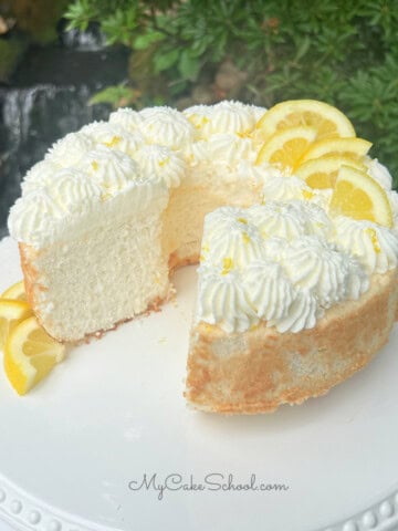 Sliced Lemon Angel Food Cake on a cake pedestal.