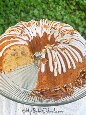 Peach pecan pound cake, sliced, on a cake pedestal.