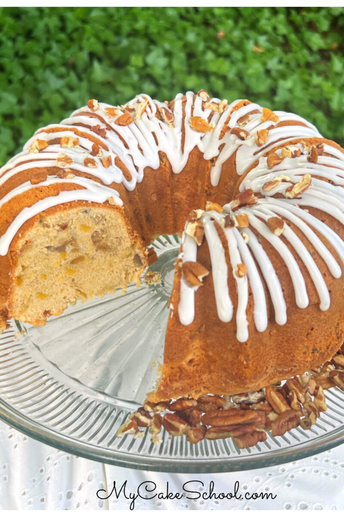 Peach Pecan Pound Cake, sliced, on a pedestal.