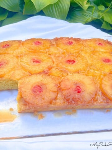 Pineapple Upside Down Sheet Cake, sliced, on a cake platter.