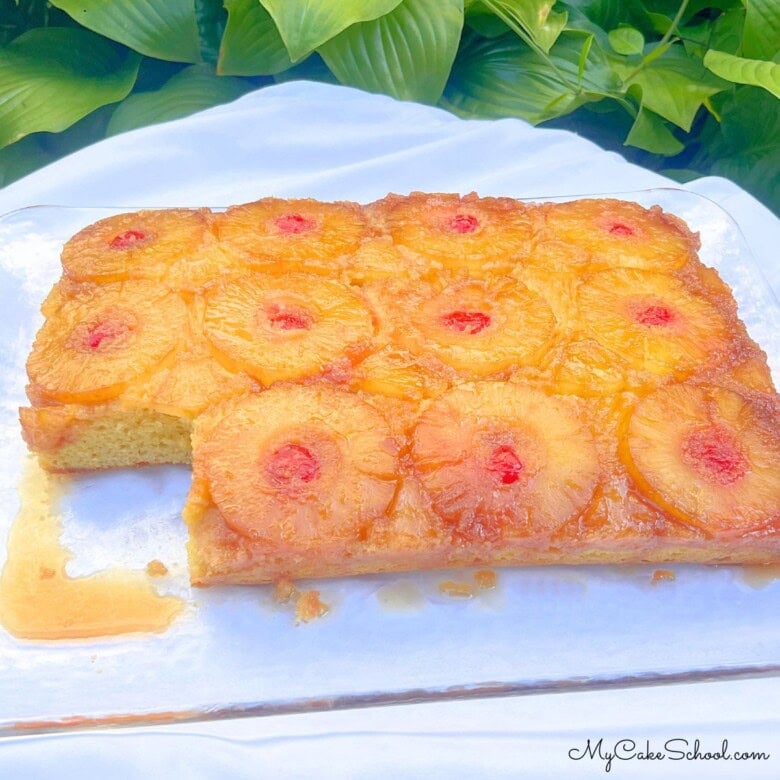 Pineapple Upside Down Sheet Cake, sliced, on a cake platter.