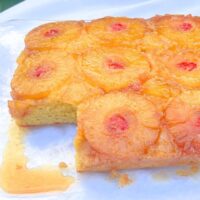 Pineapple Upside Down Sheet Cake, sliced, on a cake platter.