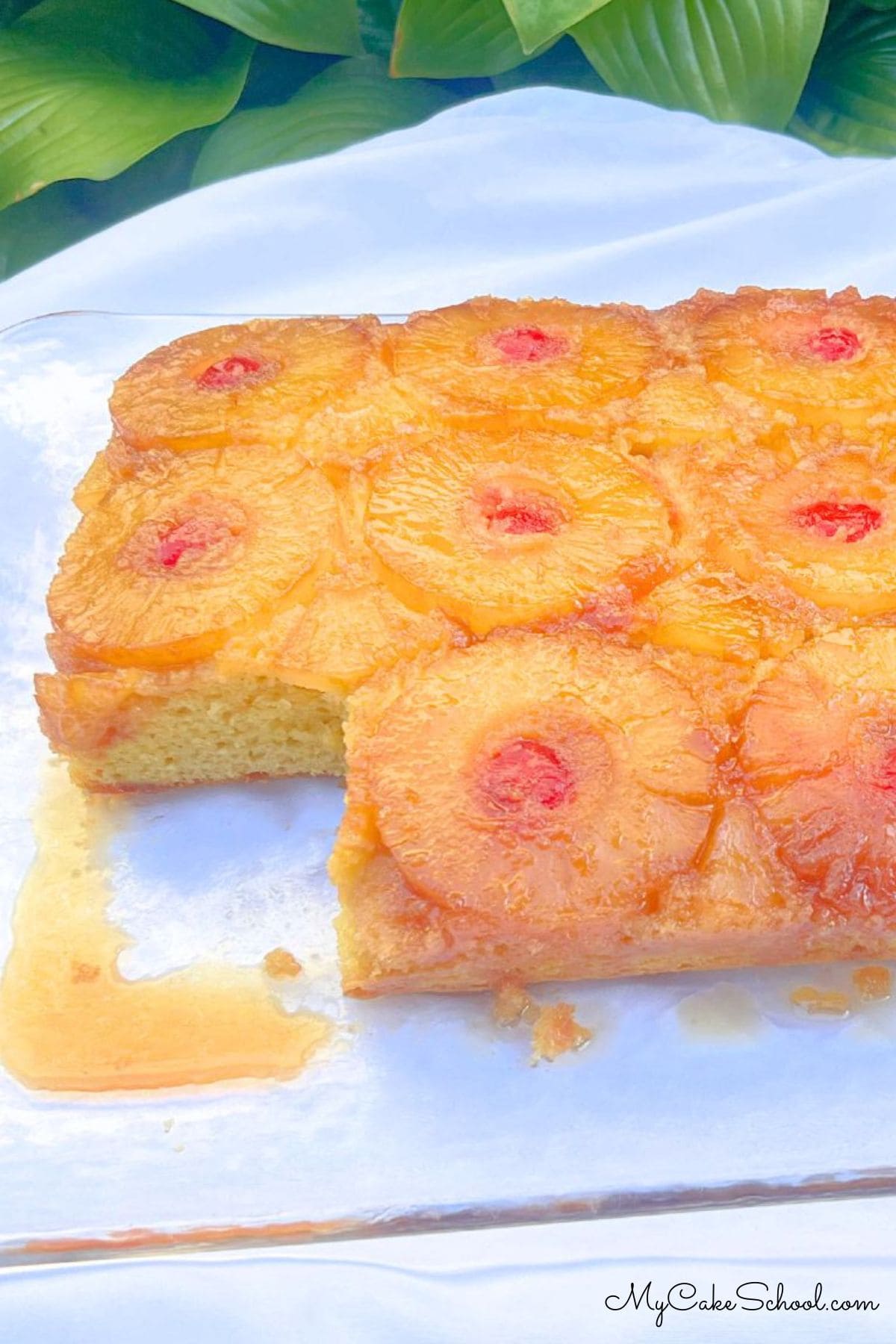 Pineapple Upside Down Sheet Cake, sliced, on a cake platter.