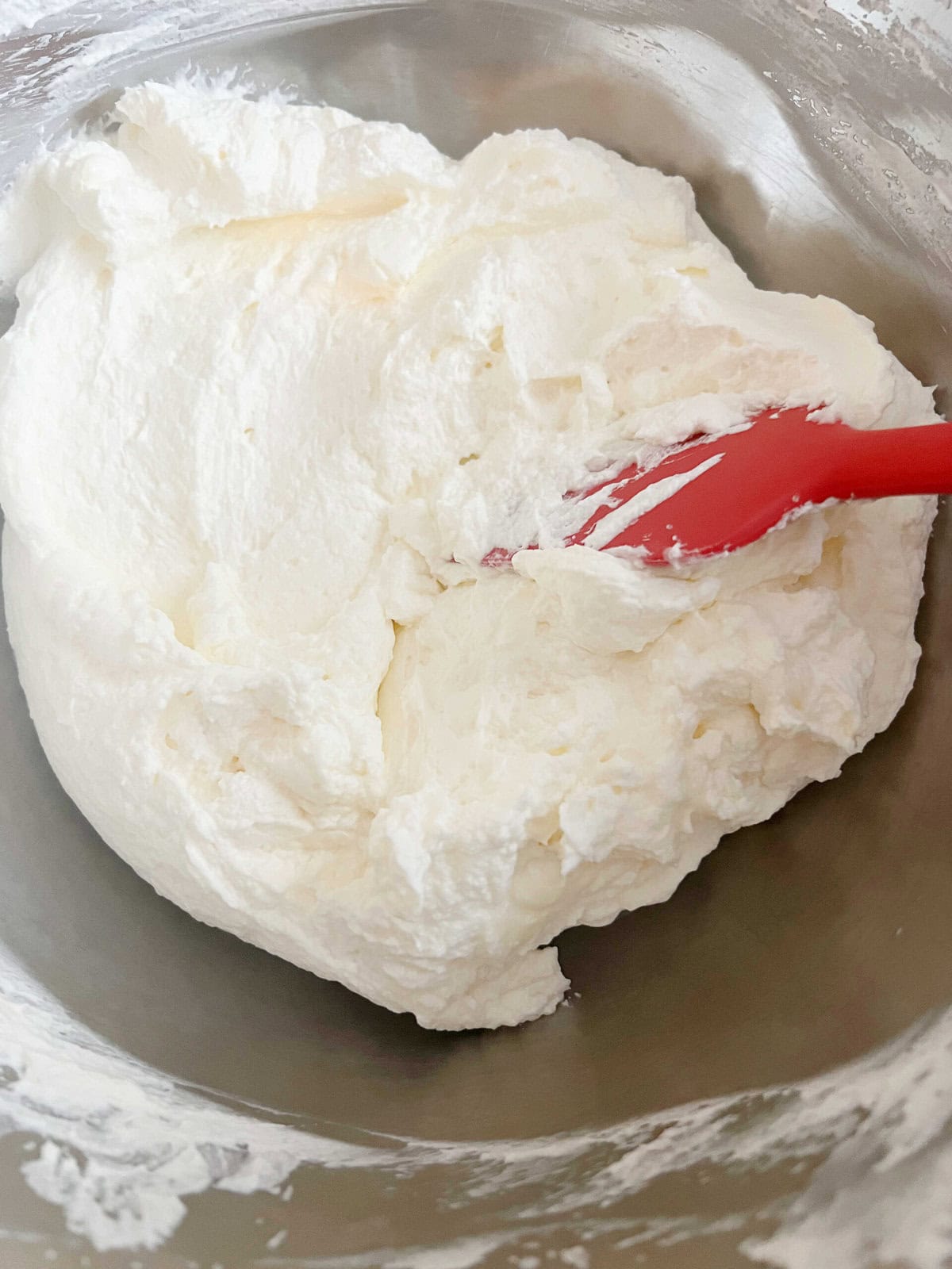 Almond Whipped Cream Cheese Frosting in a bowl.