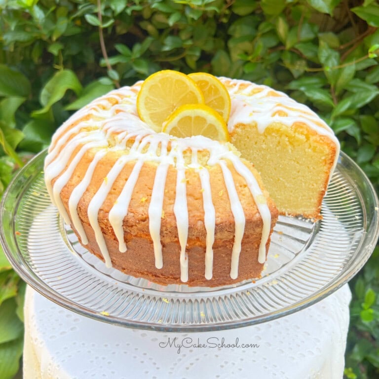 Lemon Mascarpone Pound Cake, sliced, on a pedestal.