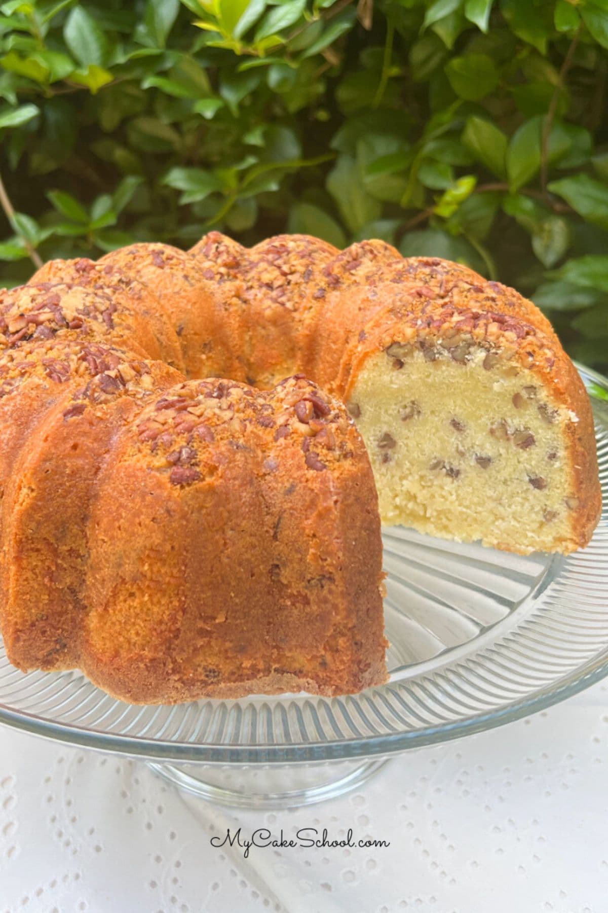 Coconut Pecan Cake, sliced, on a cake pedestal.