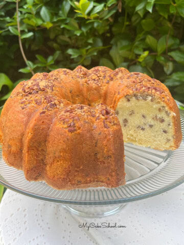 Coconut Pecan Pound Cake, sliced, on a cake pedestal.