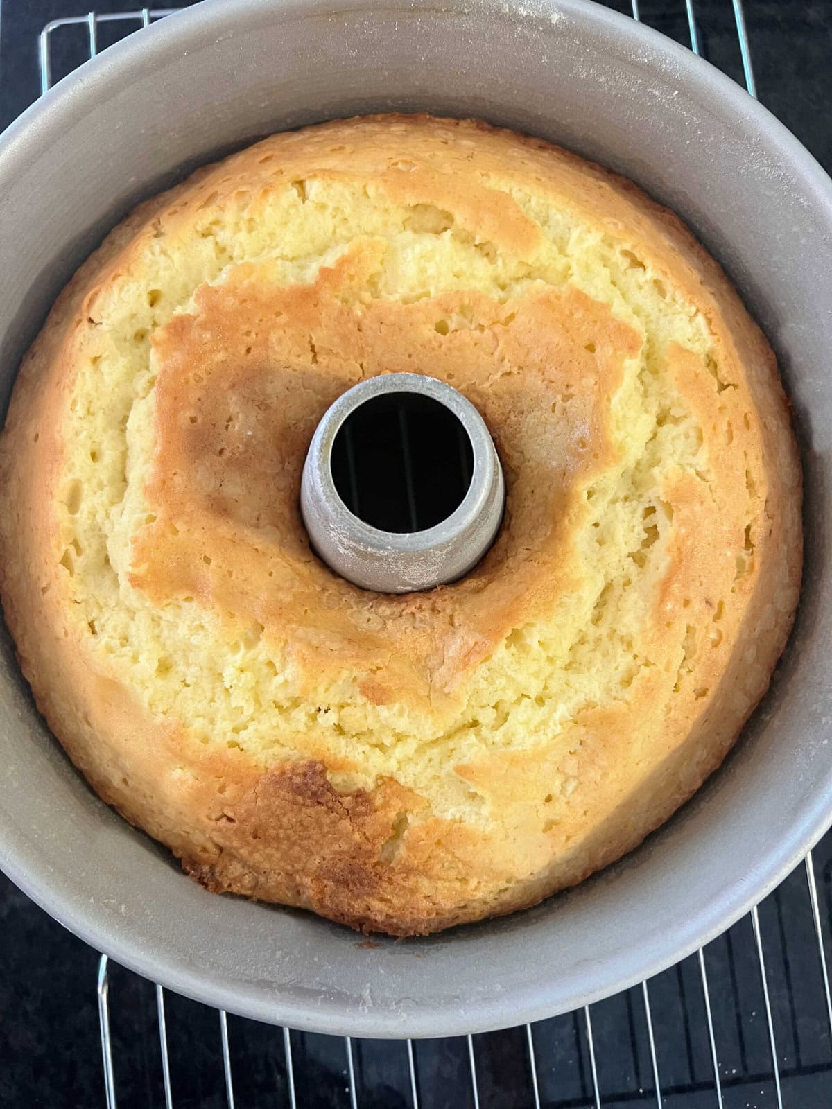 Lemon Mascarpone Pound Cake, cooling in a pan on a cooling rack.