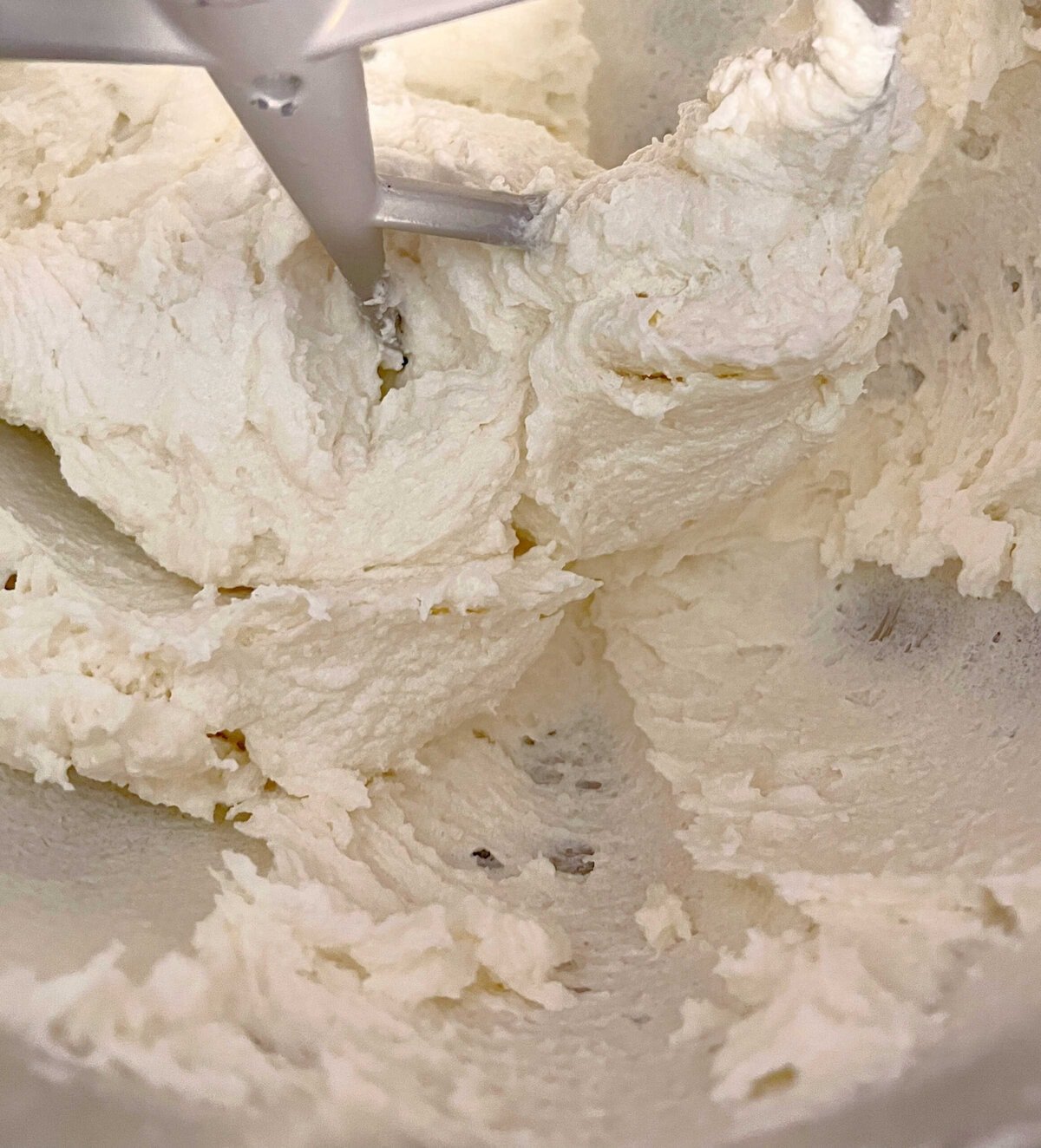 Mixing the mascarpone cheese, butter, and sugar in mixing bowl.