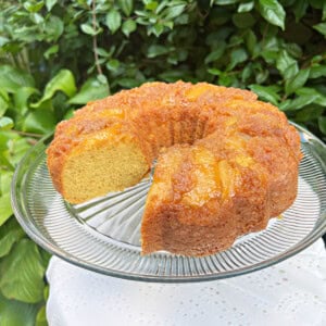 Apple Upside Down Cake, sliced, on a cake pedestal.