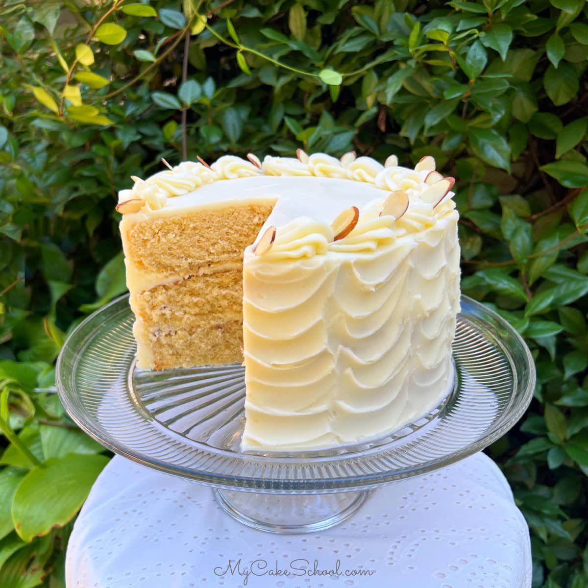 Maple Almond Cake, sliced, on a cake pedestal.