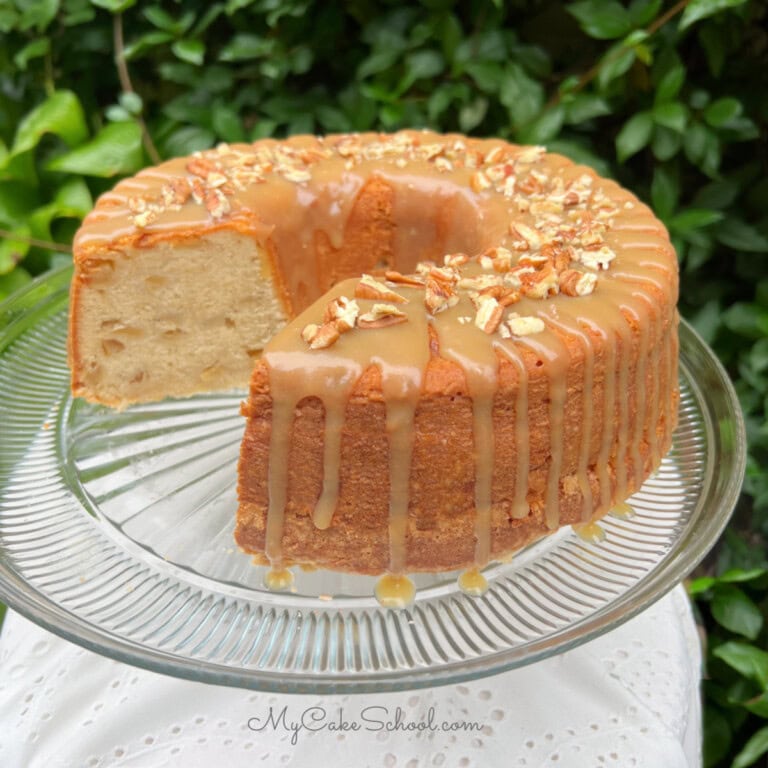 Apple Pound Cake, sliced, on a cake pedestal.