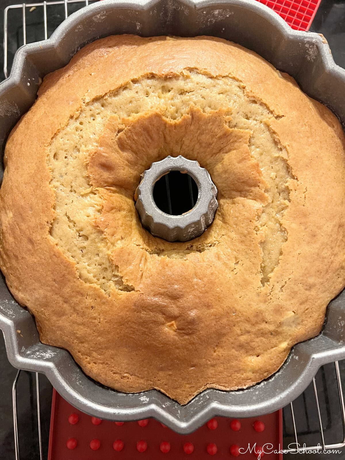 Apple Upside Down Cake, in pan, cooling on a wire rack.