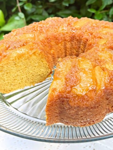 Apple Upside Down Cake, sliced, on a cake pedestal.