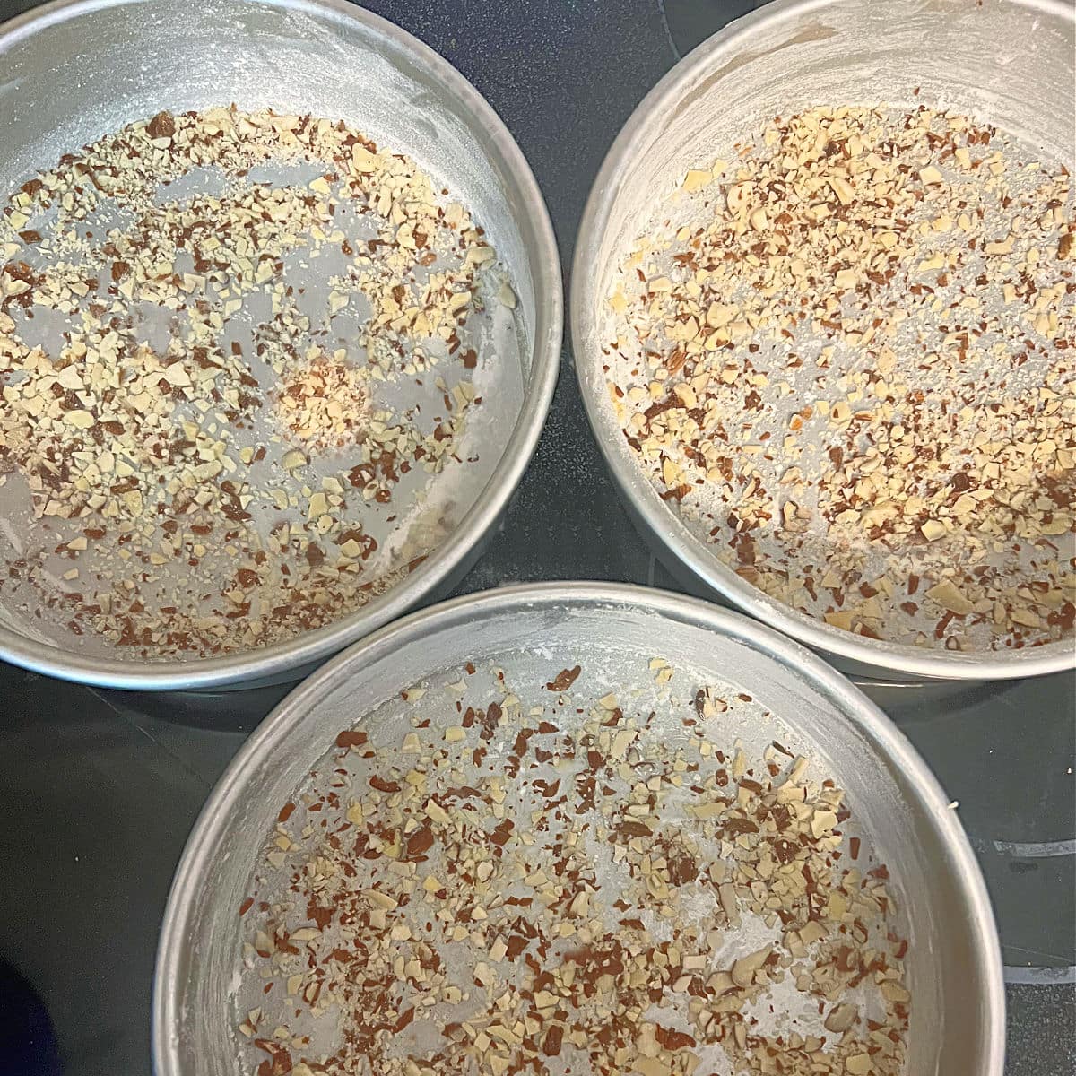 Crushed Almonds in bottom of pans.