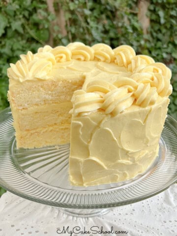 Lemonade Layer Cake, sliced, on a cake pedestal.