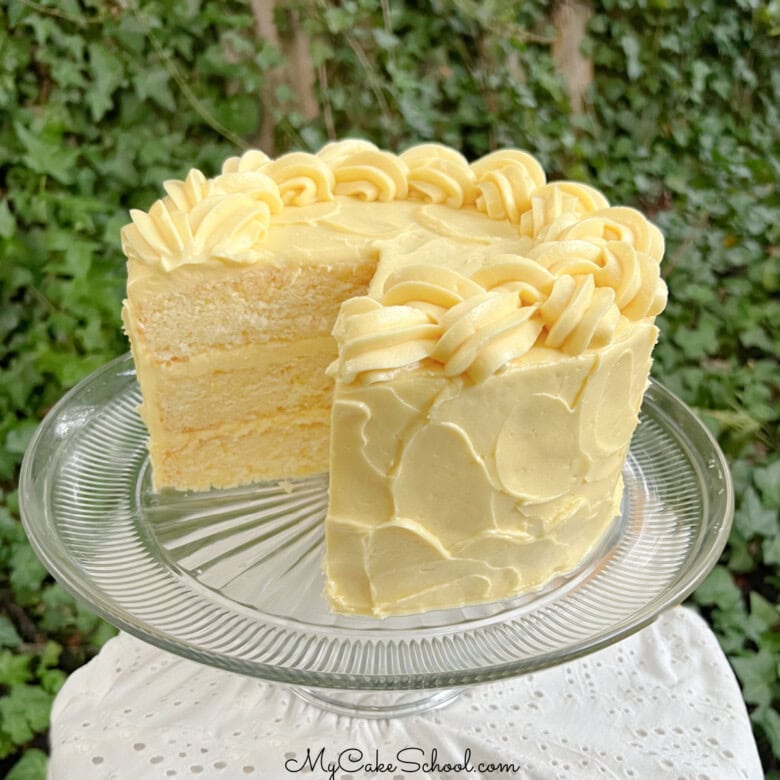 Lemonade Layer Cake, sliced, on a cake pedestal.