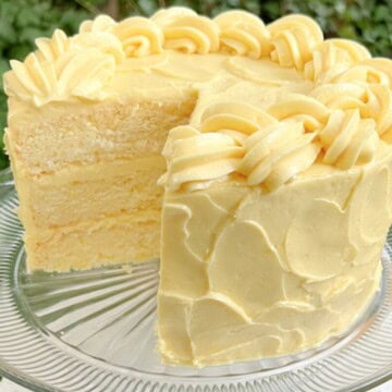 Lemonade Layer Cake, sliced, on a cake pedestal.