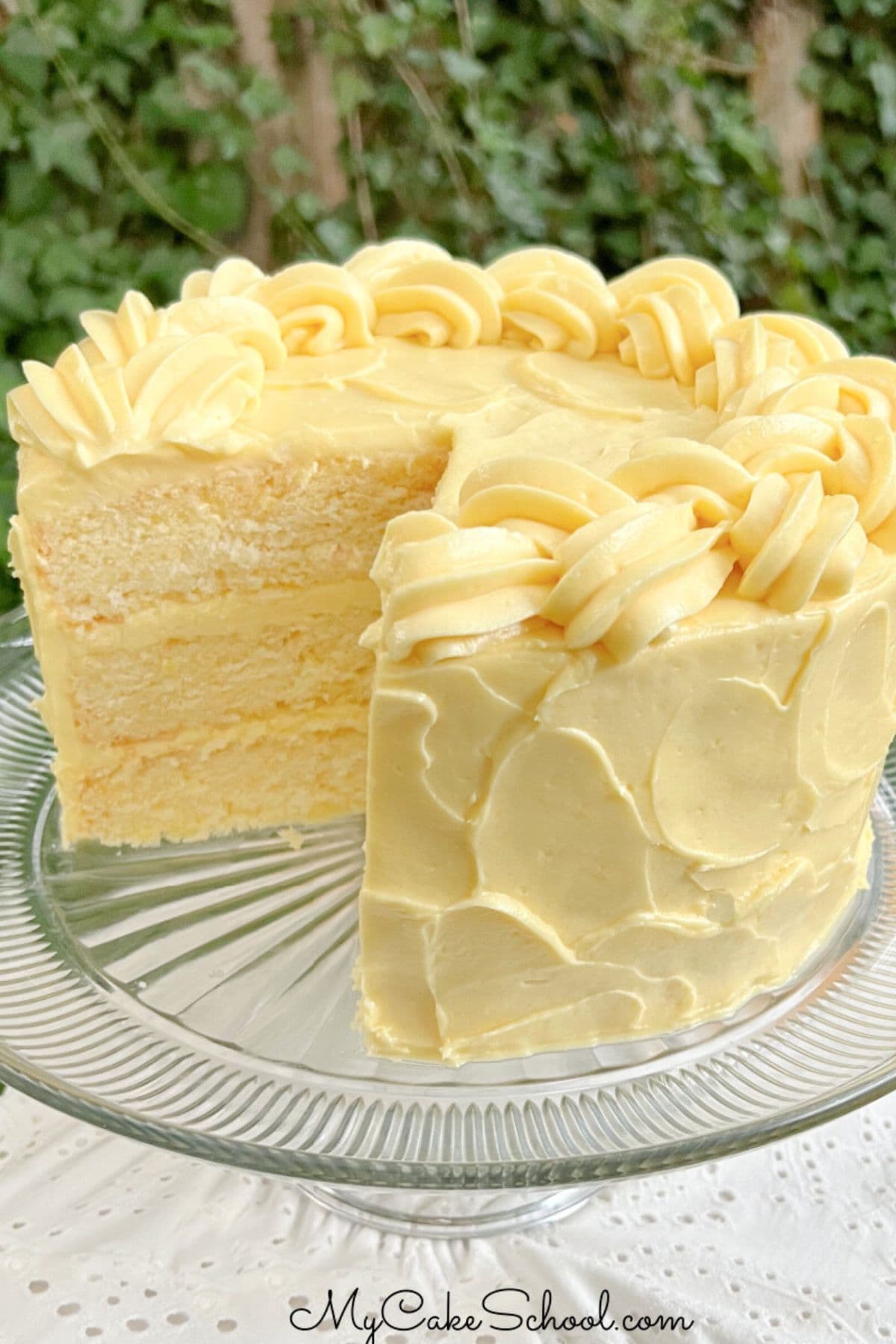 Lemonade Layer Cake, sliced, on a cake pedestal.